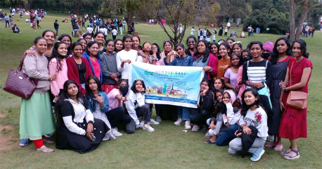 Group of travellers with Middle East Travels banner
